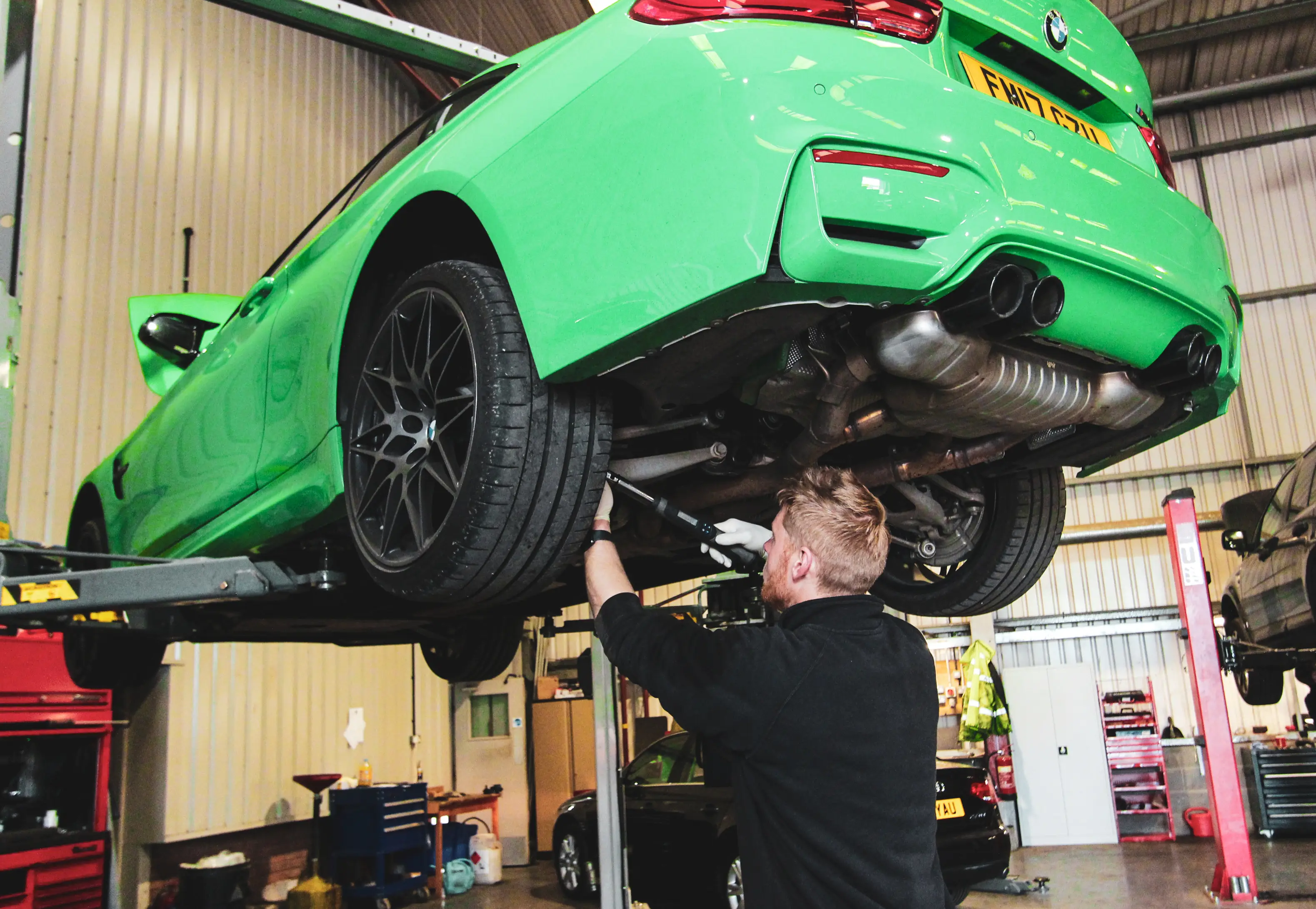 Technician repairing a BMW on the lift at Dack